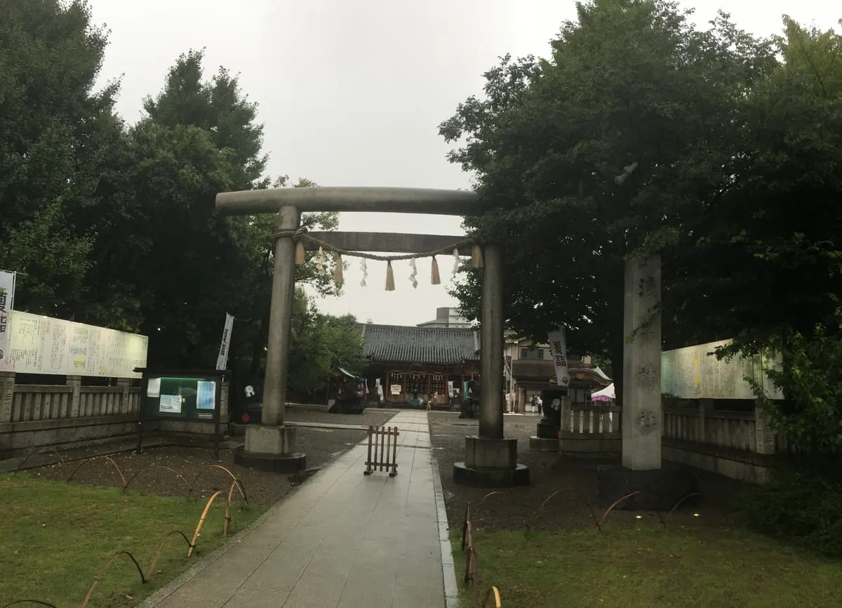 Asakusa Shrine with torii and shimenawa on a rainy day