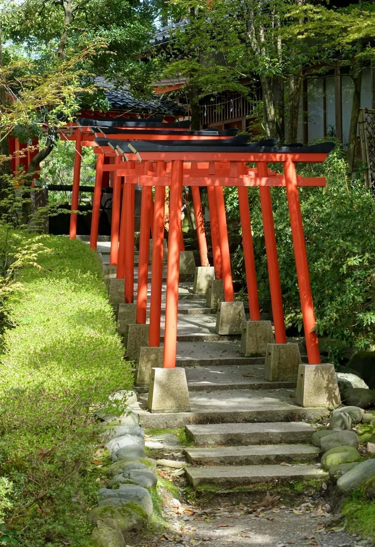 The vermillion torii of Kanazawa Shrine, standing beside the sacred Kinjoreitaku spring that gave the city its name